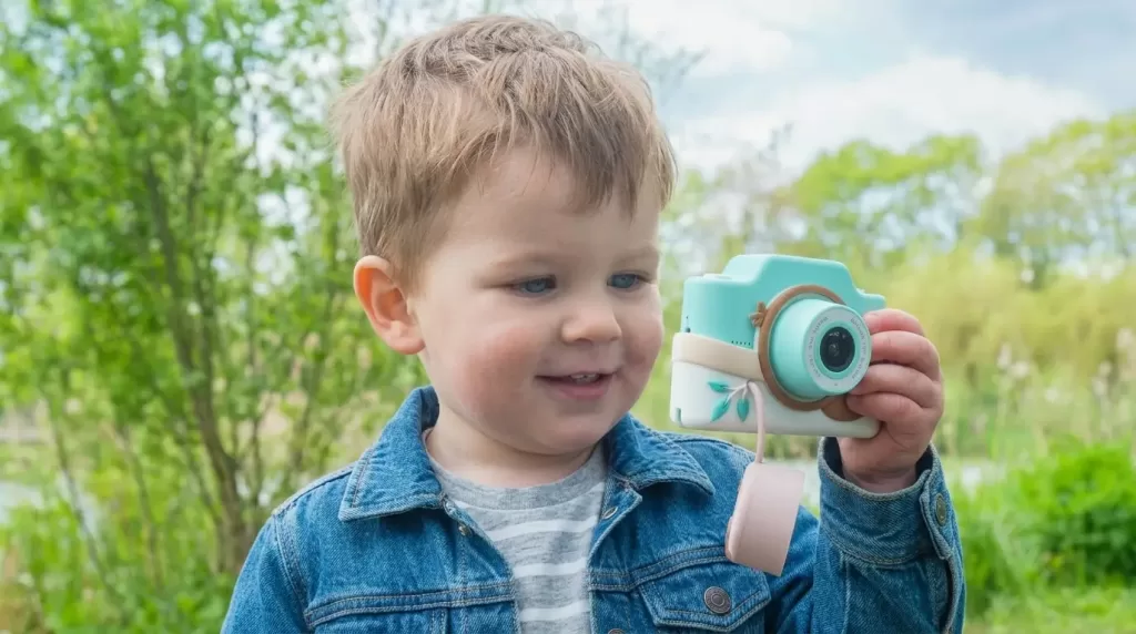 A child holding a kids digital camera